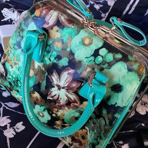 Multi color floral purse includes strap